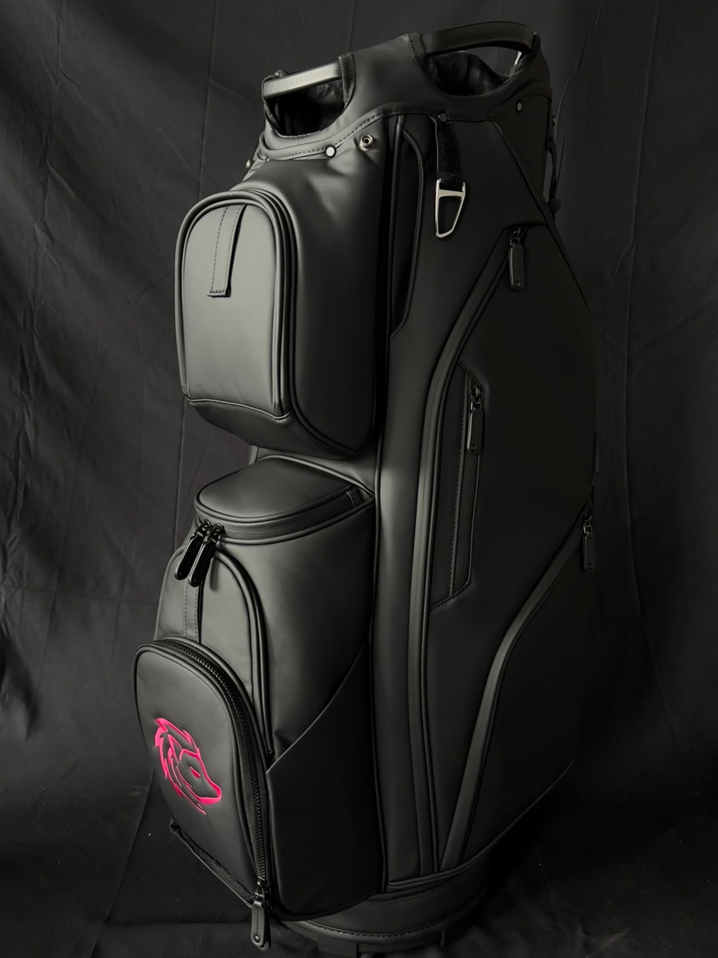 Black golf bag with a pink logo on a black background